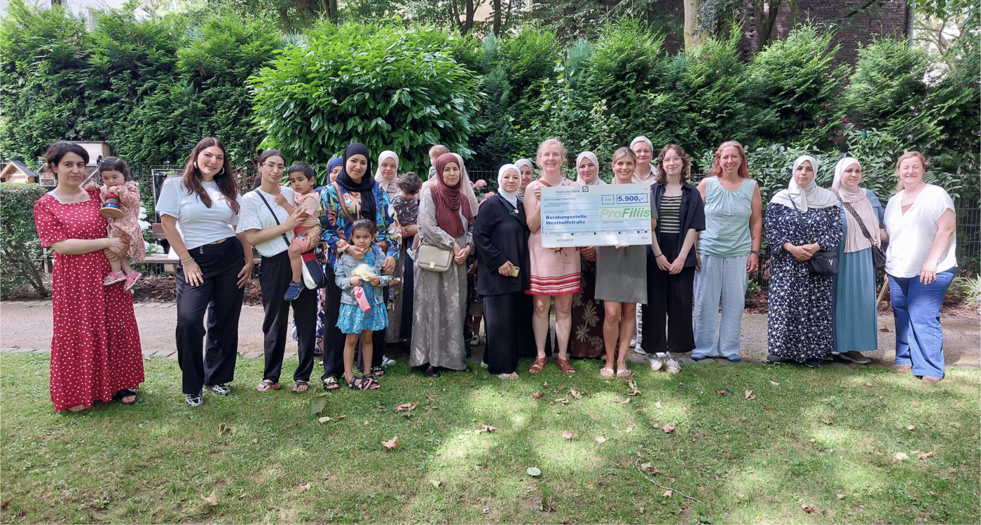 Zu sehen sind Teilnehmerinnen mit ihren Kindern, Mara Eiskirch (Praktikantin), Isabel Cramer (Vorständin des Sozialen Zentrums Dortmund e.V.), Svenja Felbier (Stiftung ProFiliis), Maria Preuß (Fachbereichsleitung der Beratungsstelle Westhoffstraße), Lisa Kuharski (Praktikantin), Laura Summann (Bewegungscoachin), Özlem Avci (Dipl. Pädagogin) (Foto: Thorsten Szelies)